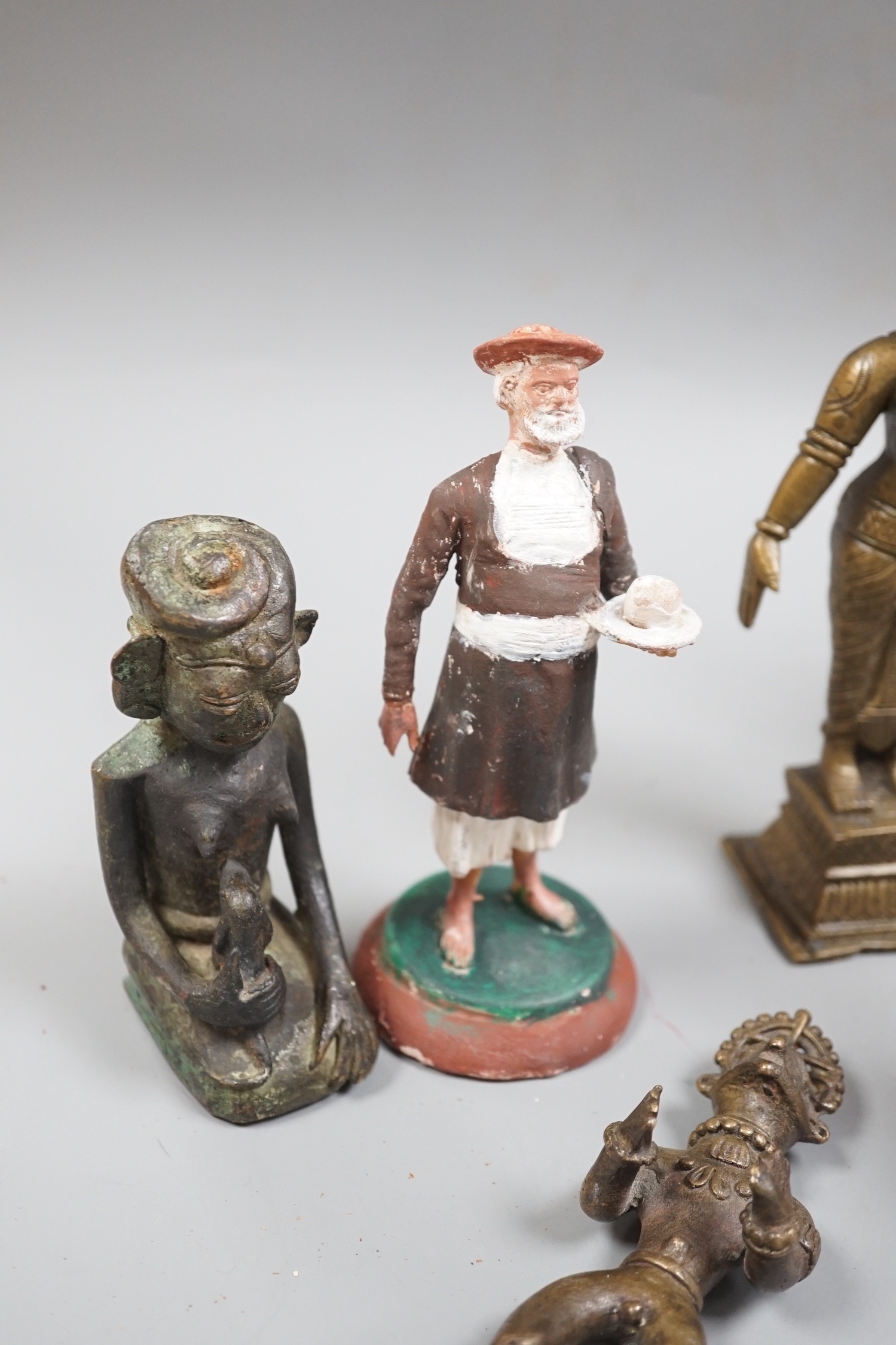 A group of Indian bronze figures of deities, tallest 20 cm and three Indian painted clay figures